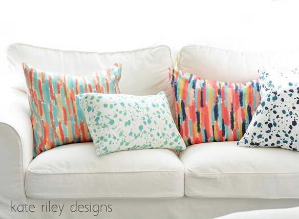 brushstrokes and splatter pillows on sofa